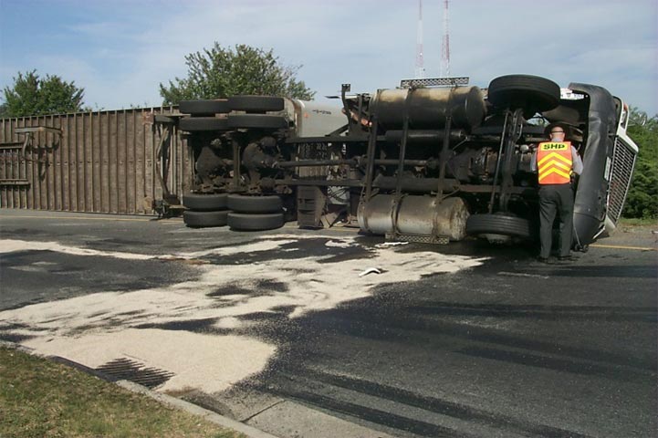 Oil and fuel discharge from overturned truck